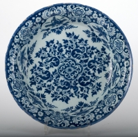A Deep Charger in Dutch Delftware with a Flower Decoration