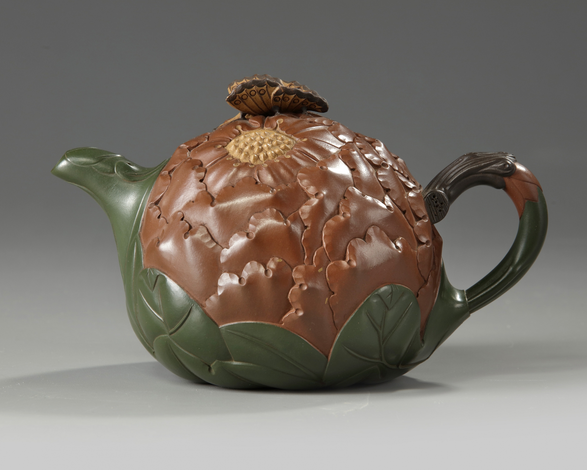 A Chinese Yixing green with brown-clay 'lotus & butterfly ...