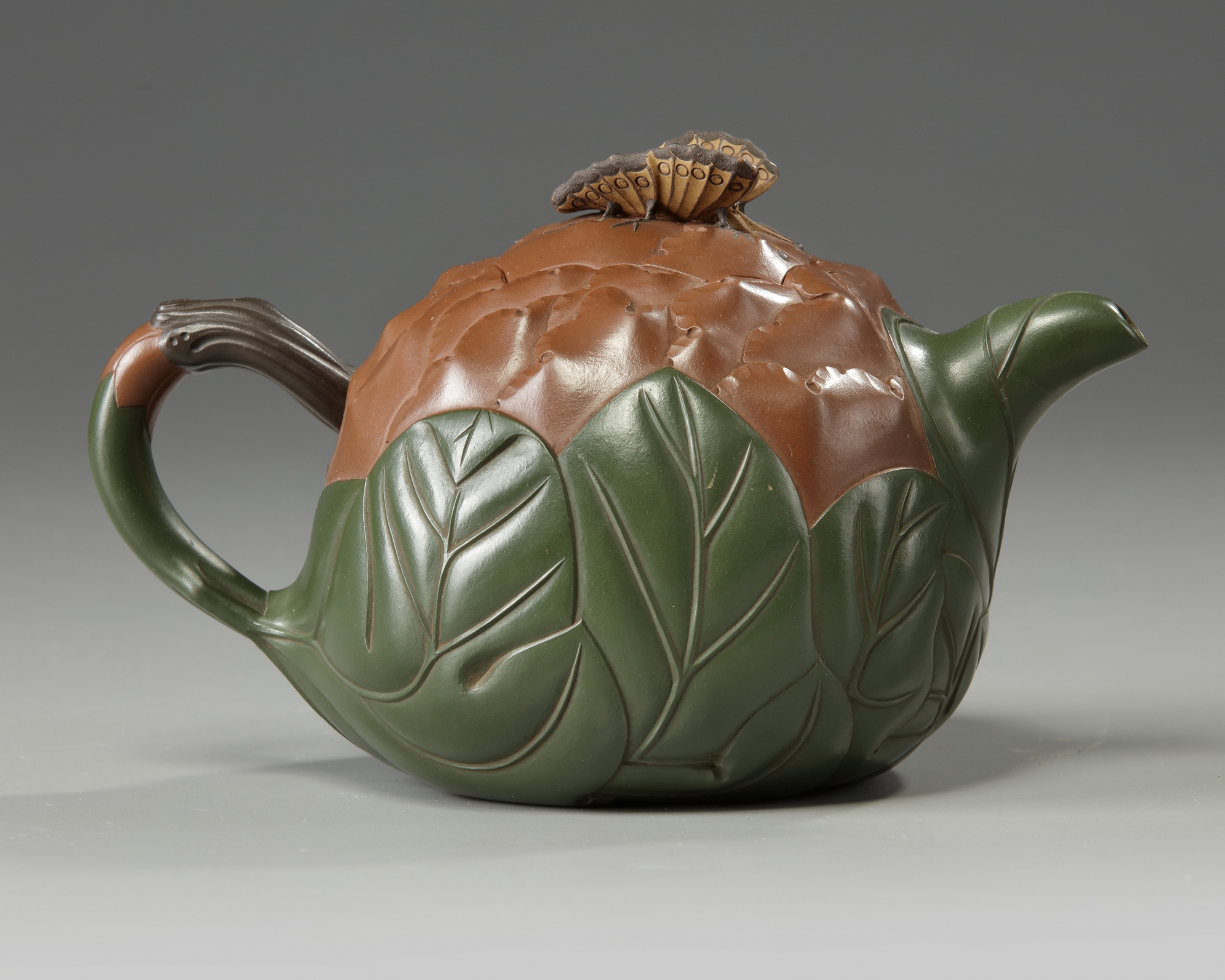 A Chinese Yixing green with brownclay 'lotus & butterfly' teapot OAA