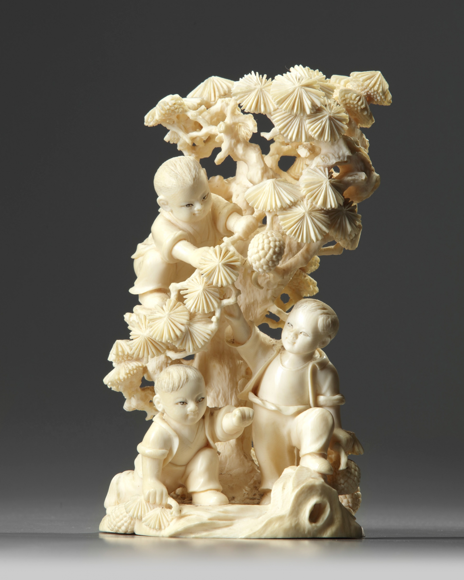 A Chinese carved ivory 'boys and pine' group OAA