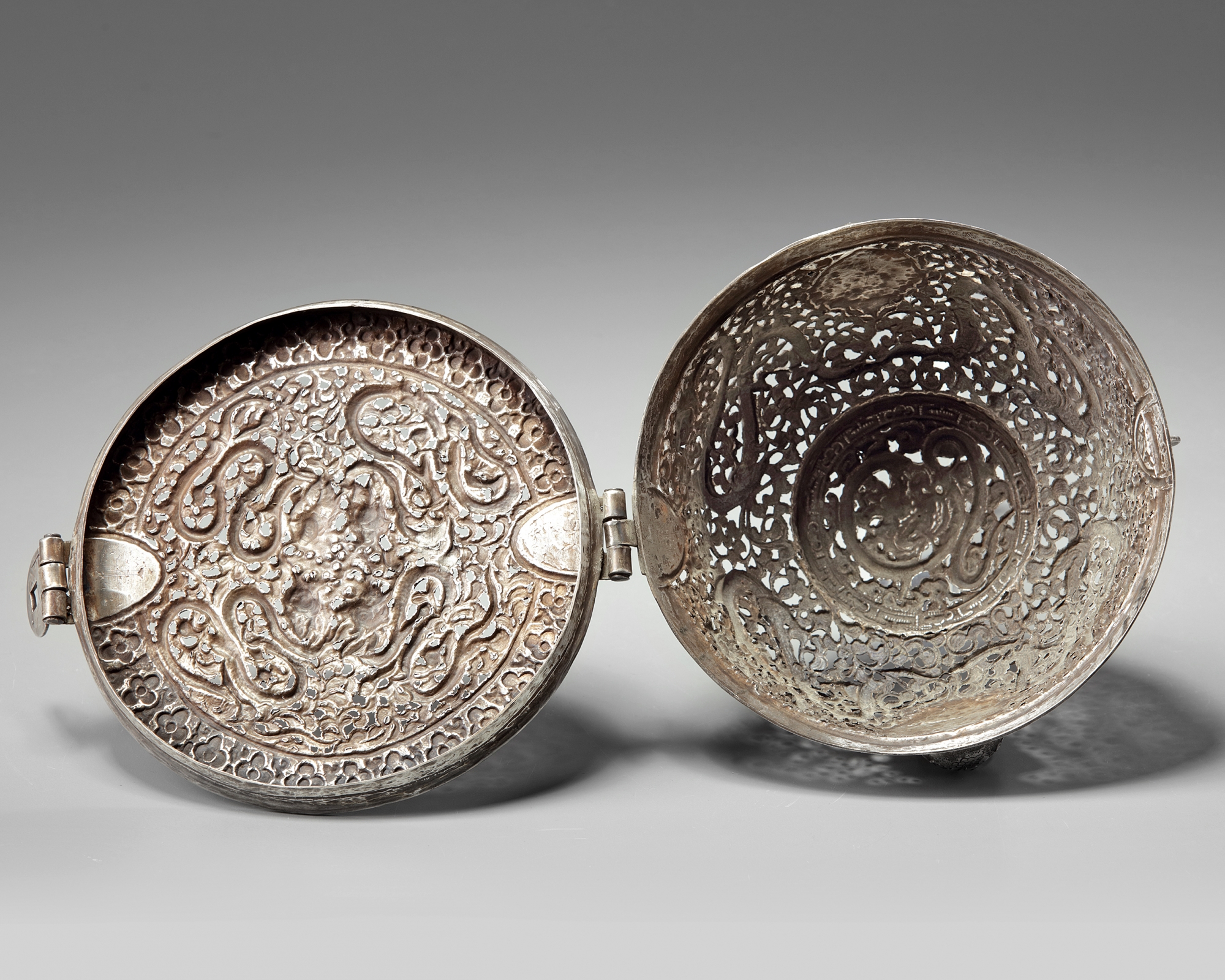 A Tibetan silver tea bowl container and hinged cover OAA
