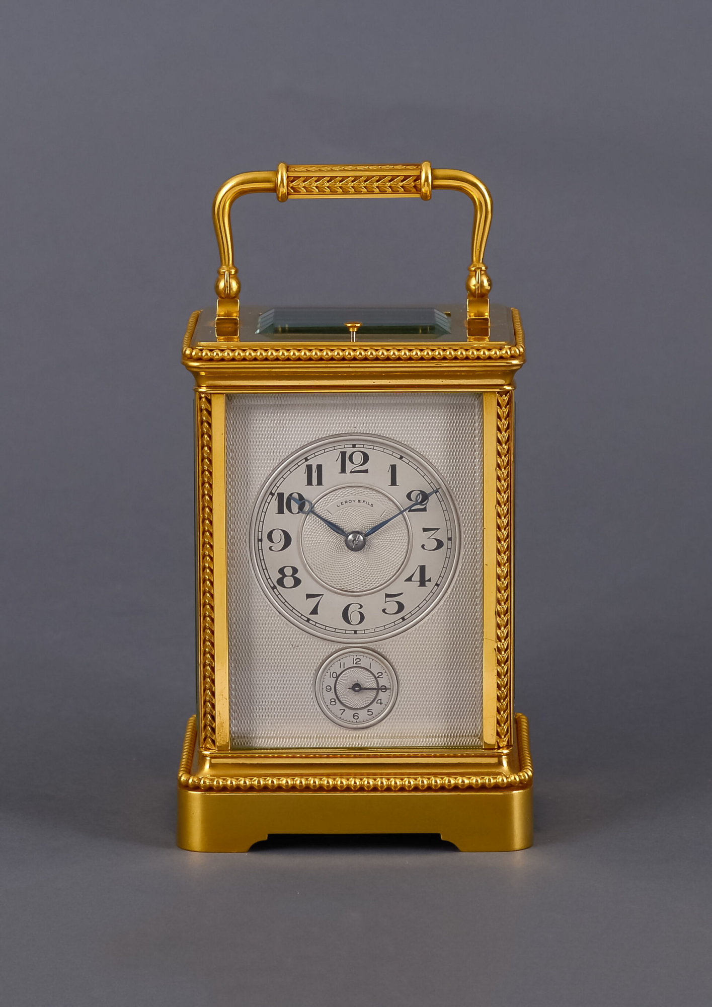 A French gilded travel clock in a Corniche case signed Le Roy & Fils ...