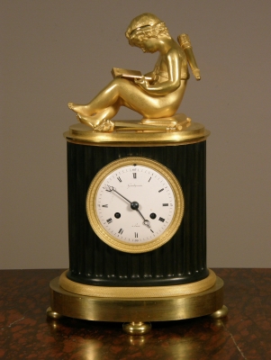A small French Empire patinated and ormolu sculptural mantel clock Grandperrin à Perrin circa 1805.