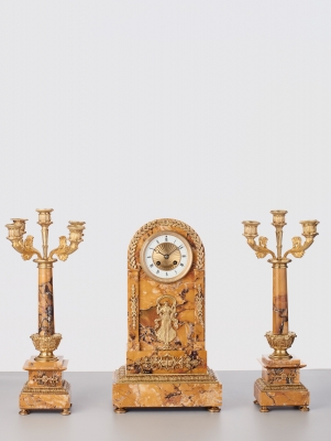 A French sienna marble clock with candle holders, circa 1890