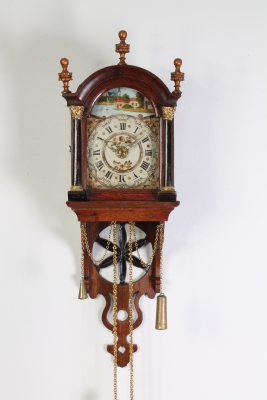 An attractive Dutch Frisian maddered oak striking alarm 'staartschippertje'wall clock, circa 1830.