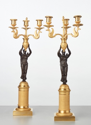 A pair of French gilt candlesticks with patinated bronze angels, circa 1820