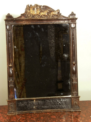 Een spiegel in houten lijst, mogelijk voormalig vertrek- en aankomsttijden lijst, ca 1880.