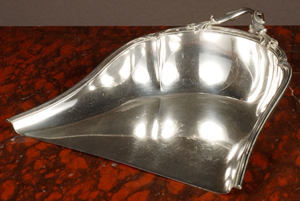 Silver dustpan with a beautifully decorated handle, circa 1880.