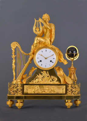 A large French fire-gilt bronze Empire mantel clock Orpheus with its lyre