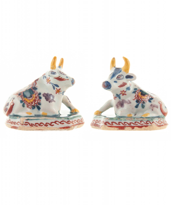 Pair of Miniature Dutch Delft Polychrome Figures of Recumbent Cows