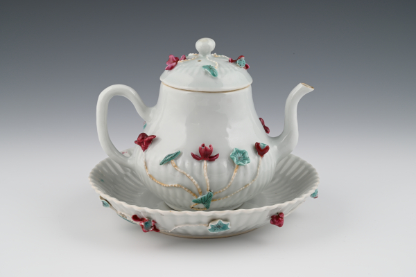 A Chinese Famille Rose teapot with the original saucer