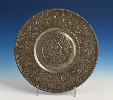A pewter relief plate