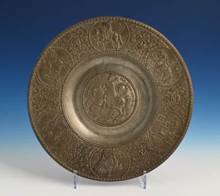 A pewter relief plate