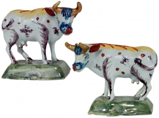 A Pair of Standing Cows in Polychrome Dutch Delftware
