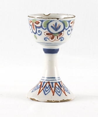 A Polychrome Decorated Egg Cup in Dutch Delftware