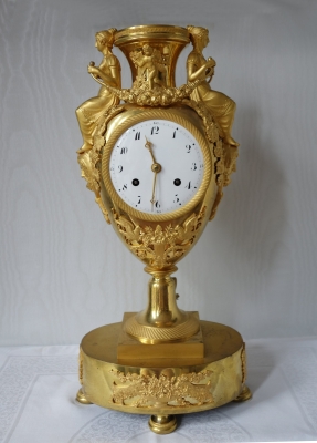 Een mooie  en zeldzame vergulde vaaspendule, Cupido en klassiek gedrapeerde vrouwenfiguren die bloemenstrengen dragen,  Frankrijk Directoire ca. 1795-1800.