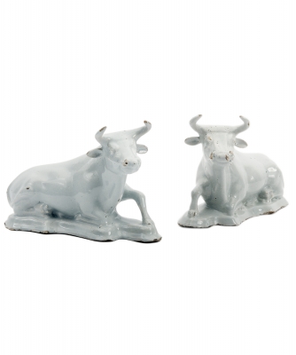 A Pair of Recumbent Cows in White Dutch Delftware