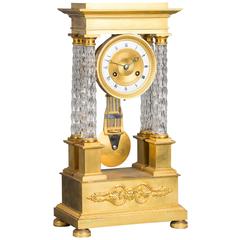 An attractive Charles X ormolu and crystal portico striking 8-day mantel clock