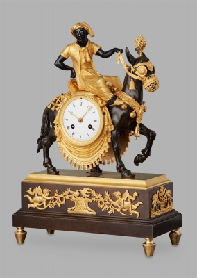 An unusual French ‘Directoire' gilt and patinated bronze mantel clock with young Arab on mule, circa 1800