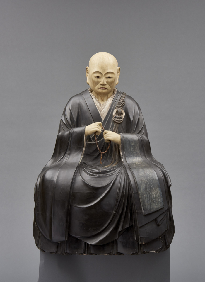 An important and very large painted wooden sculpture of a monk